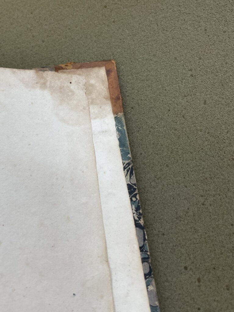 Water damaged pastedown and page