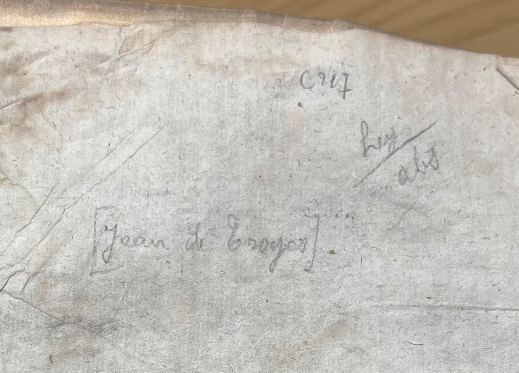 Image of the penciled note from the book seeming to read [Jean de Troyes], additionally there are two more notes. One says, "C917" and the other says "hey/abs."